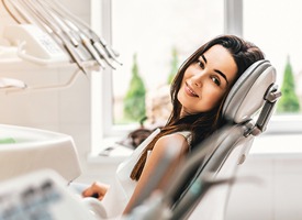 Smiling young woman in dental chair