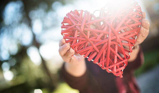 Hands holding a crafted heart