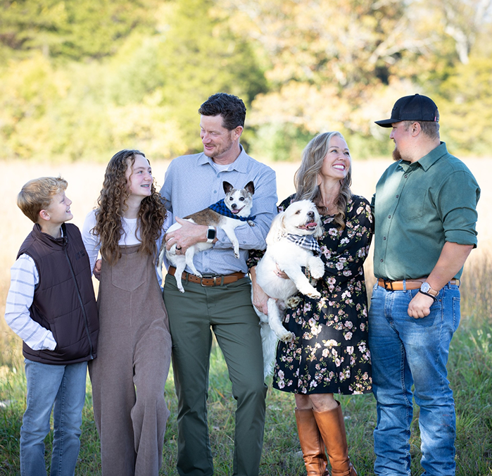 Laughing family of four in a park