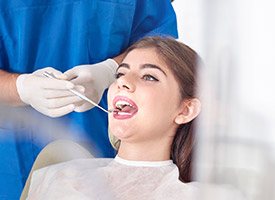 Woman receiving oral cancer screening