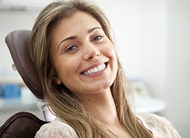 Happy woman smiling in dental chair