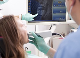 Dentist and patient looking at tooth photos